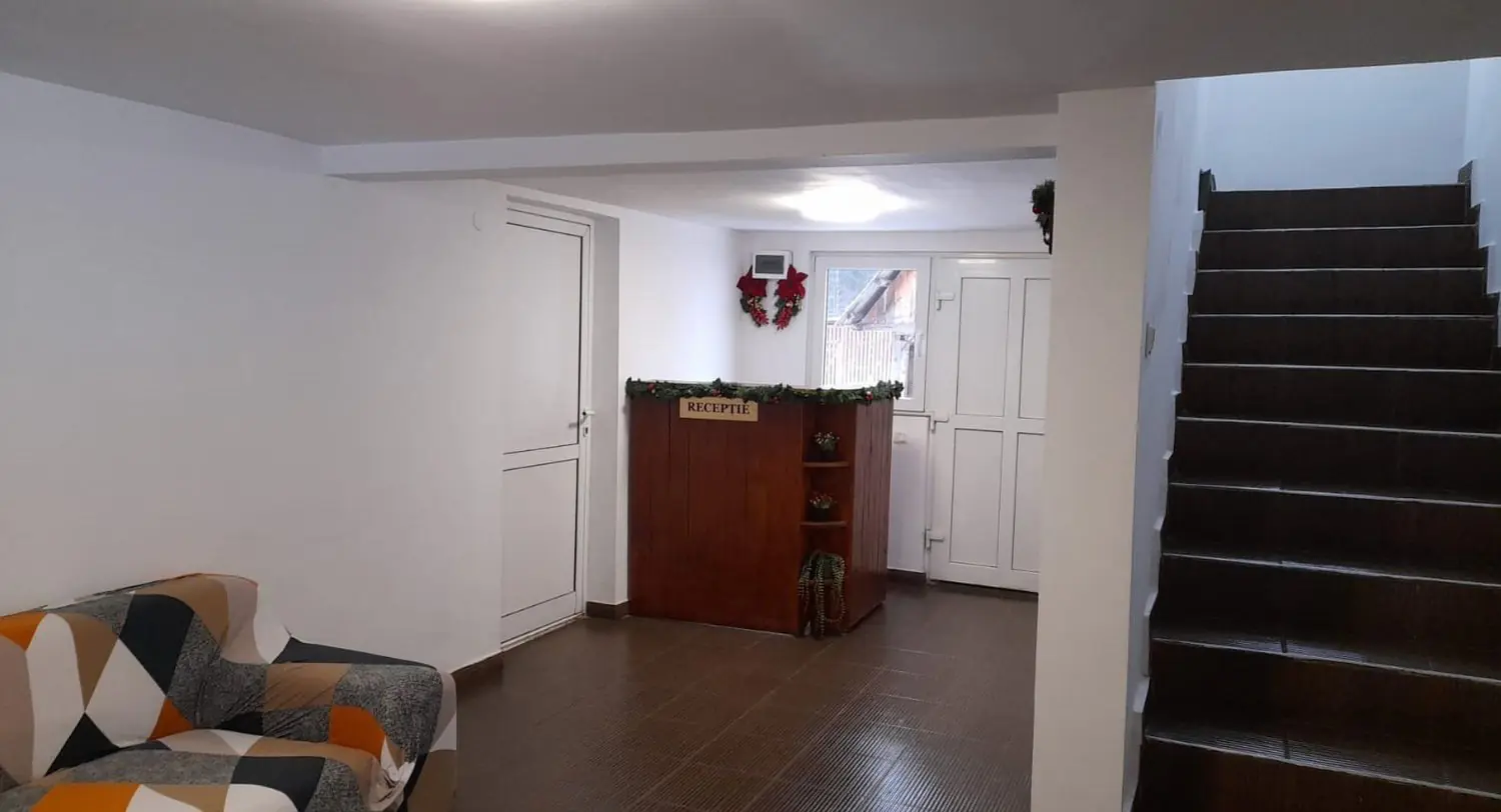 Hol la parter cu recepție, canapea și scară